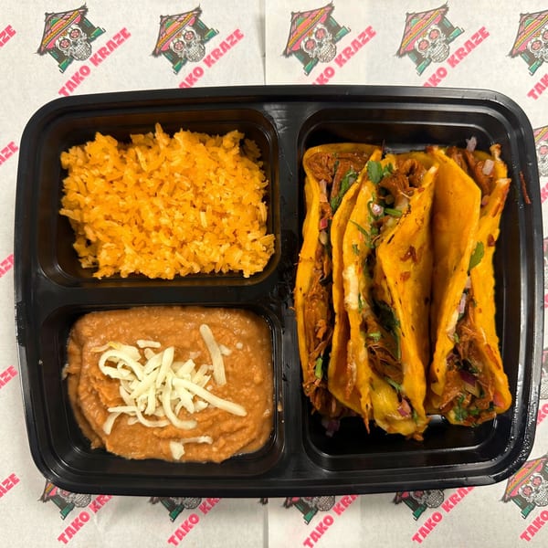 Tako Kraze birria tacos, Mexican rice, and refried beans with cheese in a black to-go container.